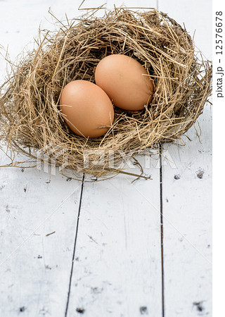 Eggs in nest on white wooden table. Eggs in nest on white wooden table. 12576678
