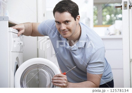 Engineer Mending Domestic Washing Machine 12578134