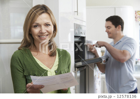 Satisfied Female Customer With Oven Repair Bill Satisfied Female Customer With Oven Repair Bill 12578136