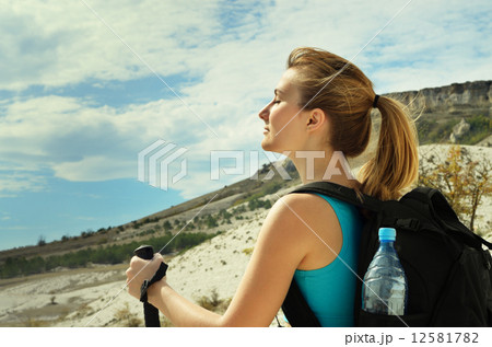 Young woman with backpack in mountains 12581782