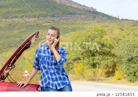Young woman near broken car 12581855