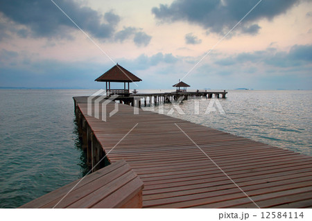 wooden bridge in the port between sunrise. 12584114