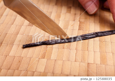 Cutting open the vanilla pod with a knife Cutting open the vanilla pod with a knife 12588035