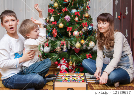 Happy mother and two her sons. Christmas photo 12589657
