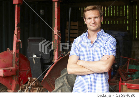 Portrait Of Farmer With Old Fashioned Tractor 12594630