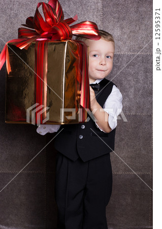 Little boy with Cristmas gift Little boy with Cristmas gift 12595371