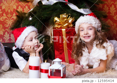 Happy children with christmas presents 12595414