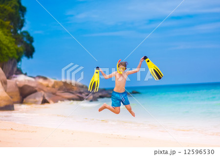Boy jumping on a beach 12596530