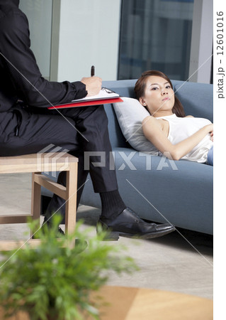 Depressed patient lying on couch Depressed patient lying on couch 12601016