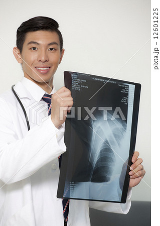 Chinese male doctor holding xray Chinese male doctor holding xray 12601225
