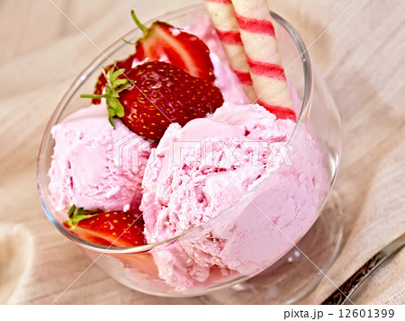 Ice cream strawberry in glass bowl with waffles on fabric 12601399