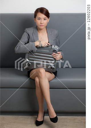 Businesswoman locked to briefcase Businesswoman locked to briefcase 12602203