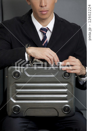 Businessman locked to briefcase 12602224
