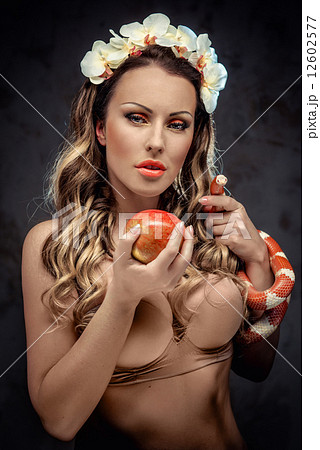 Sexy beautiful woman with red apple and snake, conceptual photo Sexy beautiful woman with red apple and snake, conceptual photo 12602577