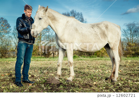 Man and horse outdoors 12602721