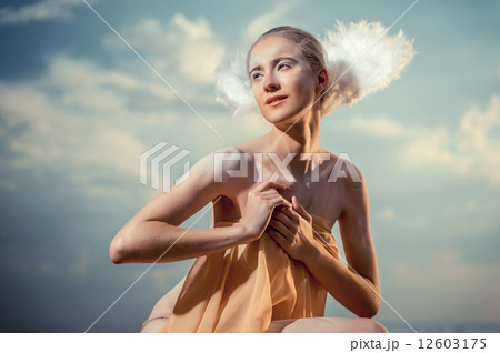 Young beautiful woman as swan posing on the beach 12603175