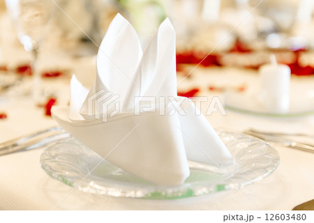 Close-up photo of folded napkin on a table at restaurant 12603480