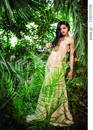 Gorgeous young woman in long evening dress in a forest 12603506