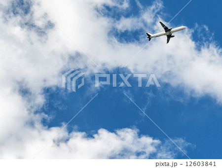Airplane over cloudy sky background 12603841