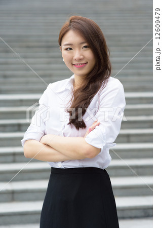 one young successful chinese office lady in front of steps outdoor one young successful chinese office lady in front of steps outdoor 12609479
