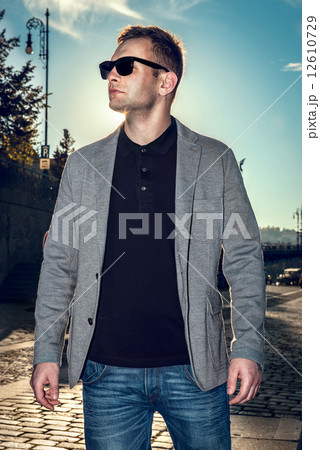 Young stylish sexy handsome model man in casual cloth lifestyle in the street in glasses 12610729