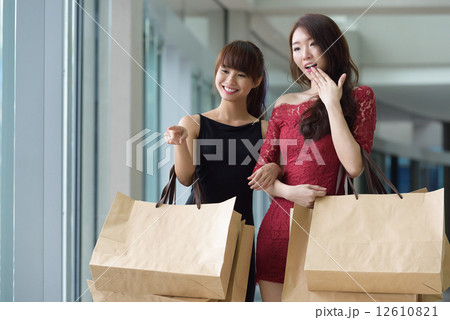 2 young chinese women shopaholic with shopping bags in the mall 2 young chinese women shopaholic with shopping bags in the mall 12610821