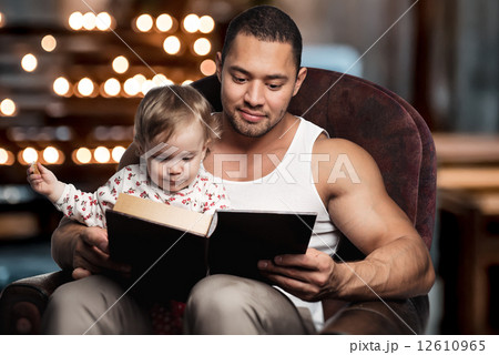 Father reading book to daughter Father reading book to daughter 12610965