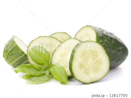 Sliced cucumber vegetable and basil leaves still life 12617705