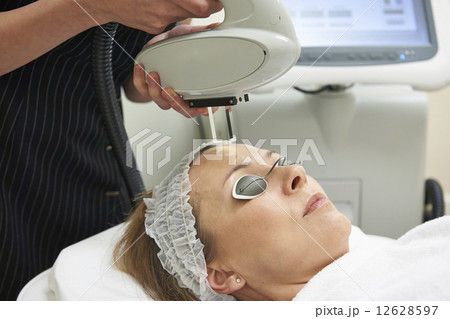 Beautician Carrying Out Intense Pulse Light Treatment Beautician Carrying Out Intense Pulse Light Treatment 12628597