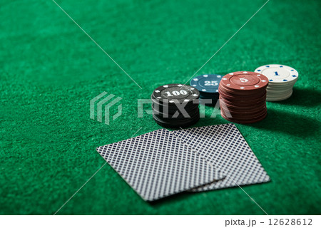 cards on the green poker table 12628612