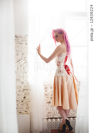 Freaky young female model wearing corset 12636224