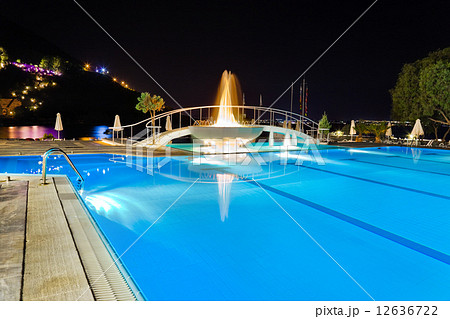 Water pool and fountain at night 12636722