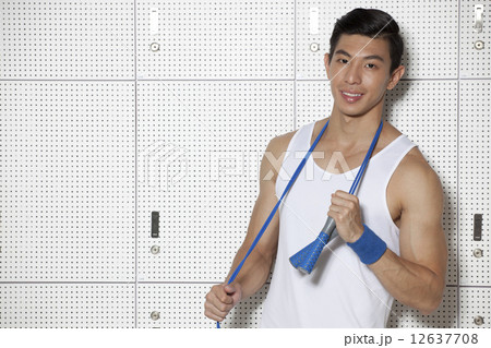 Fit Asian man with skip rope 12637708