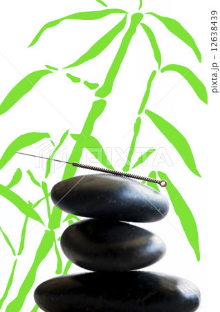 acupuncture needle on stone pyramid 12638439