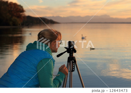Cute woman movie sunset with swans 12643473