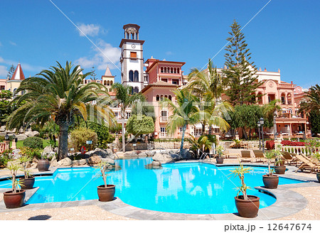 Tower with clock and swimming pool at the luxury hotel, Tenerife Tower with clock and swimming pool at the luxury hotel, Tenerife 12647674
