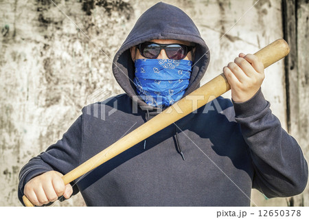 Man with a baseball bat on old wall background  12650378