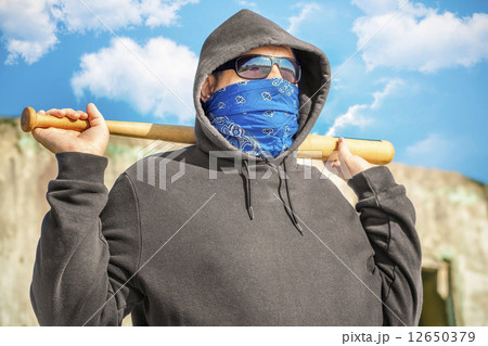 Man with a baseball bat on blue sky background 12650379