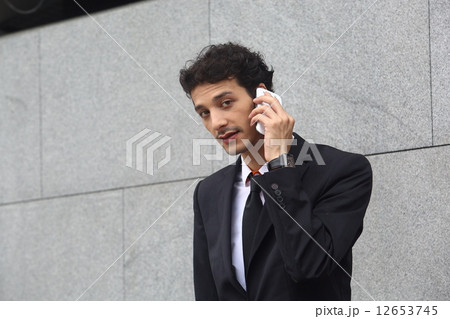 携帯電話で話す外国人男性 12653745