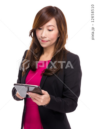 Mature businesswoman read on digital tablet 12658510