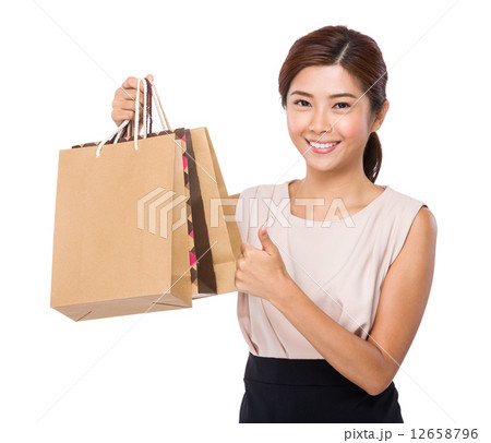 Woman with paper bag and thumb up Woman with paper bag and thumb up 12658796