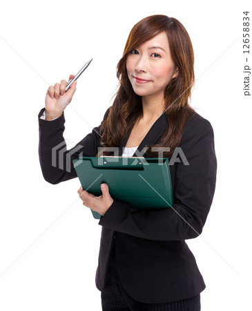 Mature businesswoman with clipboard and pen point out Mature businesswoman with clipboard and pen point out 12658834