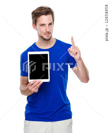 Man show with the blank screen of tablet and finger point up 12658958