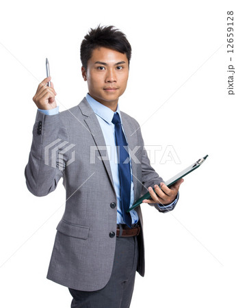 Asian businessman with clipboard and pen point up Asian businessman with clipboard and pen point up 12659128