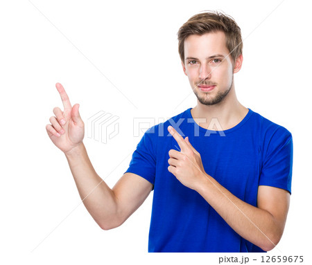Young man with two finger point up 12659675