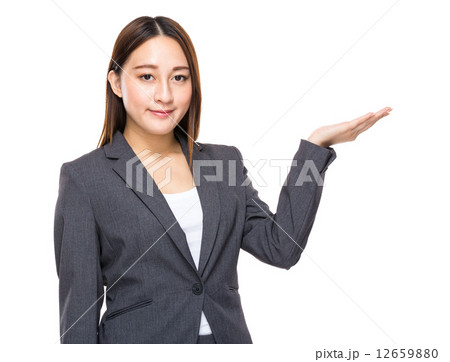 Businesswoman with hand presentation Businesswoman with hand presentation 12659880