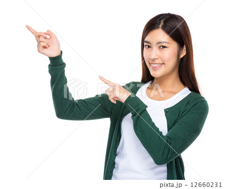 Woman with two finger point aside 12660231