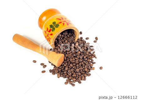 Many coffee beans in a wooden mortar with authentic pattern and 12666112