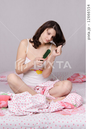 Sad girl waking up brushing her hair Sad girl waking up brushing her hair 12666554