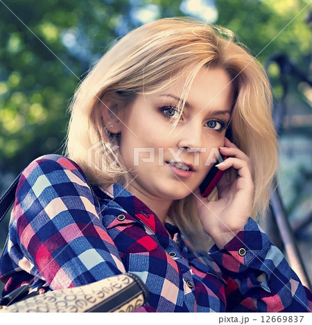 young blond girl talking on the phone young blond girl talking on the phone 12669837